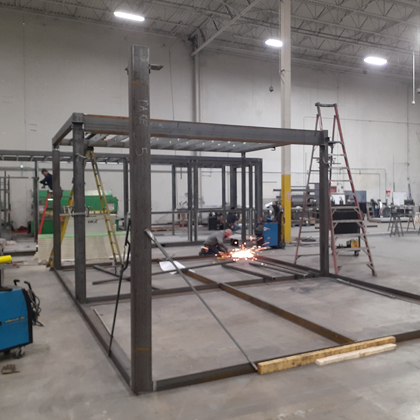 The steel frame is being built using modular construction techniques in an off-site factory.